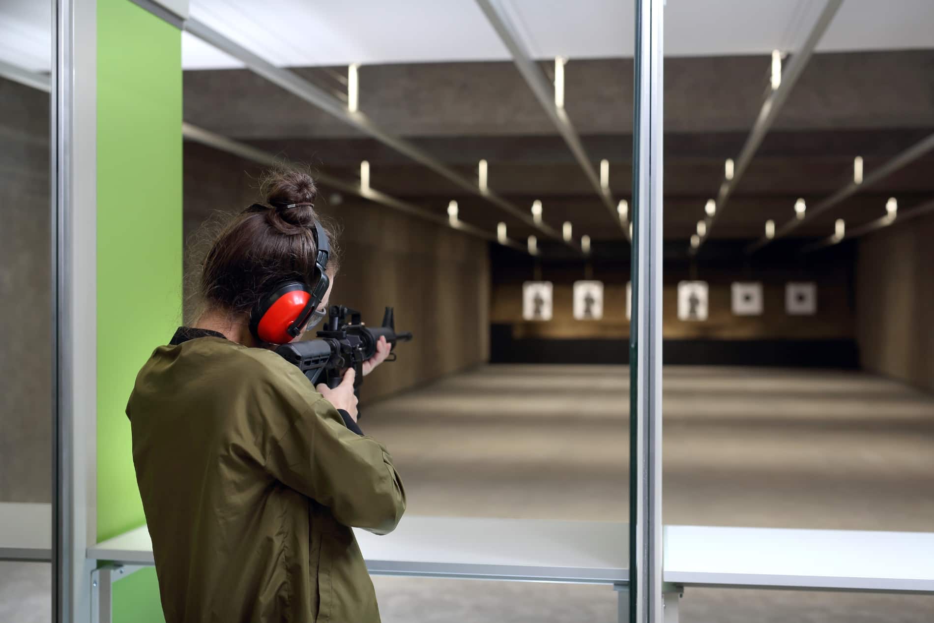 woman shooting rifle down range